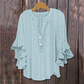 Blouse élégante à col en V et manches à volant